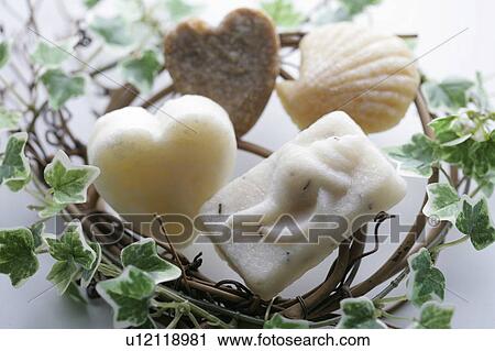 Stock Image - Bars of soap in middle of vine holder. Fotosearch