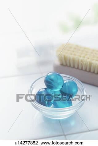 Stock Image - Bath beads and nail brush in bathroom. Fotosearch