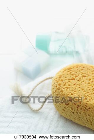 Bath sponge, bar of soap and bottle on towel View Large Photo Image Picture - Bath sponge, bar of soap and bottle on towel. Fotosearch