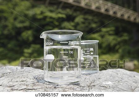 Stock Photo - Beakers on rock. Fotosearch