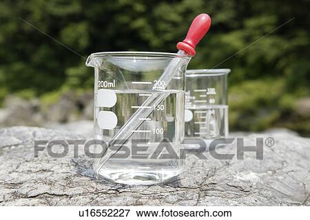 Stock Photo - Beakers on rock. Fotosearch