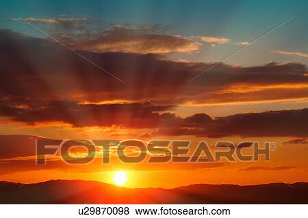 Stock Photo - Beautiful sunrise over landscape. Fotosearch