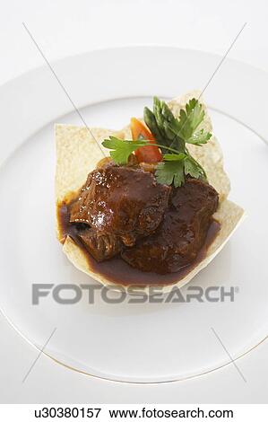 Stock Photo - Beef stew in poppadum. Fotosearch