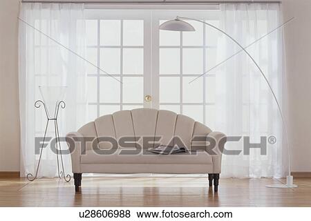 Beige sofa in room with glass doors View Large Photo Image Stock Photo - Beige sofa in room with glass doors. Fotosearch
