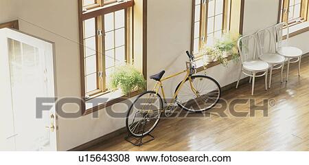 Bicycle and chairs in spacious room View Large Photo Image Stock Photo - Bicycle and chairs in spacious room. Fotosearch