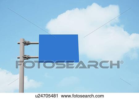 Stock Image - Blank blue signpost under clouds. Fotosearch