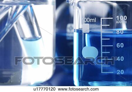 Stock Image - Blue liquid in beaker, close up. Fotosearch