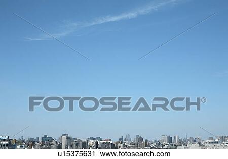 Stock Image - Blue sky over office buildings, copy space, Tokyo prefecture, Japan. Fotosearch