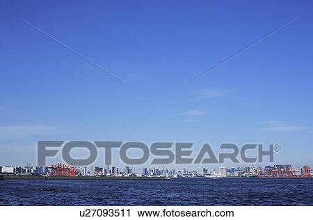 Stock Image - Blue sky over office buildings, copy space, Tokyo prefecture, Japan. Fotosearch