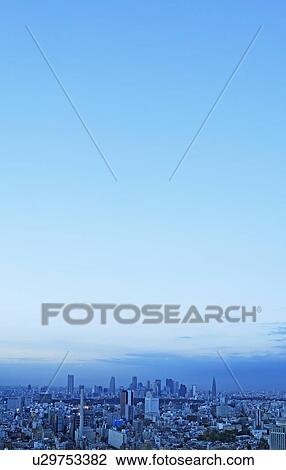 Stock Image - Blue sky over office buildings, copy space, Tokyo prefecture, Japan. Fotosearch