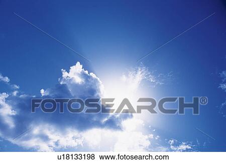 Blue sky with clouds and sun View Large Photo Image Stock Photo - Blue sky with clouds and sun. Fotosearch