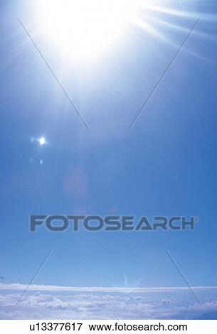 Stock Photo - Blue sky with sunbeams. Fotosearch