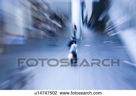 Stock Image - Blurred Image of People Walking Through a Station. Nagoya, Aichi Prefecture, Japan. Fotosearch