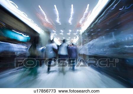 Stock Image - Blurred Image of People Walking Through a Station. Kita-ku, Osaka Japan. Fotosearch