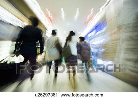 Stock Image - Blurred Image of People Walking Through a Station. Kita-ku, Osaka Japan. Fotosearch