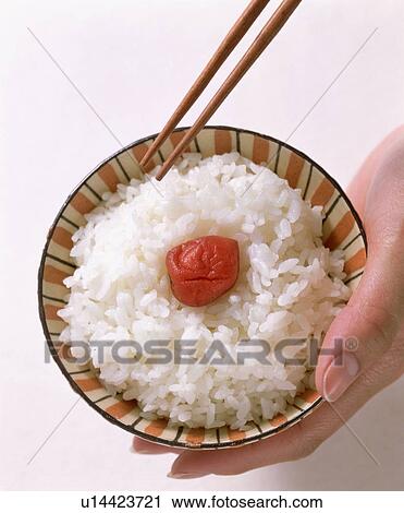 Stock Image - Boiled rice with pickled plum. Fotosearch