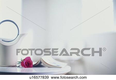 Stock Photo - Book and pink rose with white jug. Fotosearch
