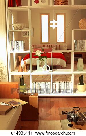 Stock Image - Bookshelf separating bedroom from lounge. Fotosearch
