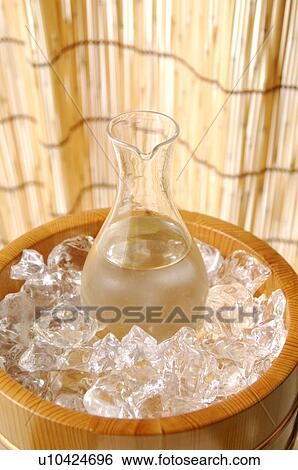 Stock Photograph - Bottle of Sake in ice bucket. Fotosearch