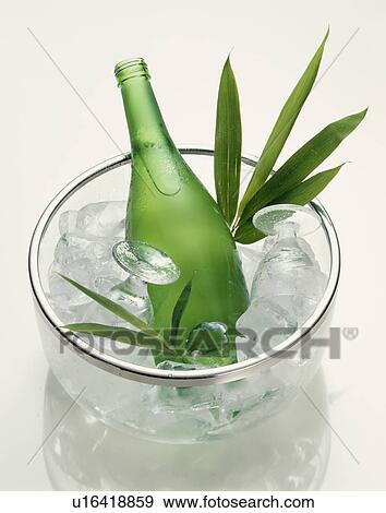 Stock Photo - Bottle of Sake in ice bucket, white background. Fotosearch