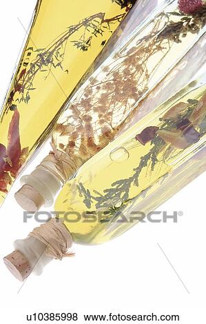 Stock Photo - Bottles of Olive Oil with Herbs and Spices. Fotosearch