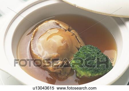 Stock Photography - Bowl of cooked clam and broccoli, close up. Fotosearch
