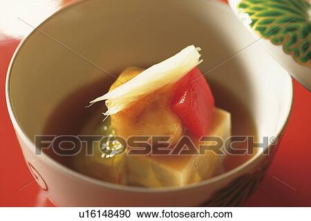 Stock Image - Bowl of cooked vegetables, close up, red background. Fotosearch