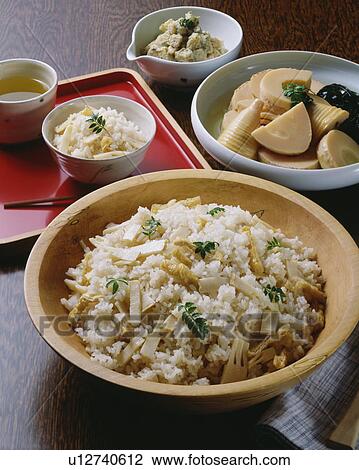 Stock Image - Bowl of rice cooked with bamboo shoots. Fotosearch