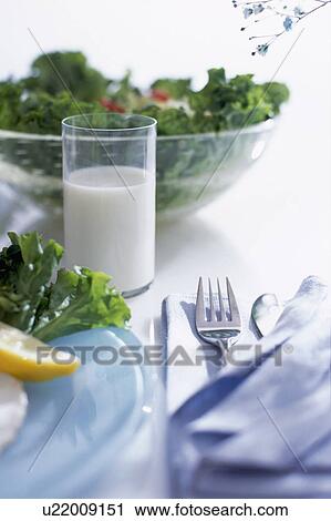 Stock Image - Bowl of salad and glass of milk. Fotosearch