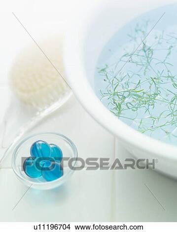 Picture - Bowl with herbs and toiletries on tile. Fotosearch
