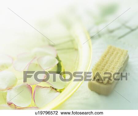 Stock Image - Bowl with petals and nail brush. Fotosearch