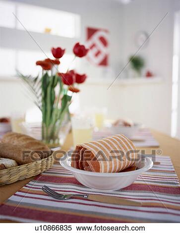 Stock Photography - Bread and bowl on table with flowers. Fotosearch