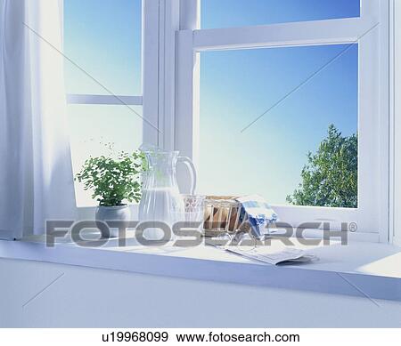 Stock Photo - Bread and milk with plant on window sill. Fotosearch