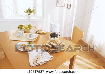 Stock Photo - Breakfast arranged on dining table. Fotosearch