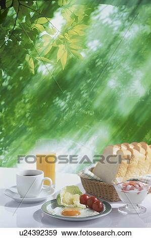 Breakfast served outdoors on a sunny morning View Large Photo Image Stock Photo - Breakfast served outdoors on a sunny morning. Fotosearch