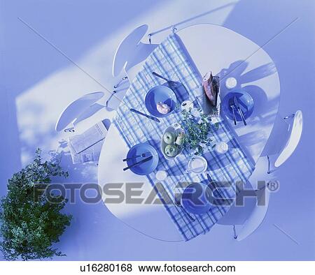 Stock Photo - Breakfast table and chairs with green plant. Fotosearch
