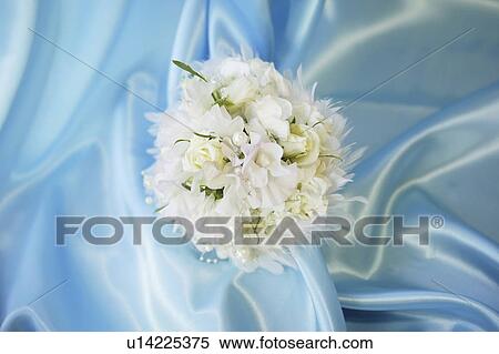 Stock Photography - Bridal bouquet on blue silk. Fotosearch
