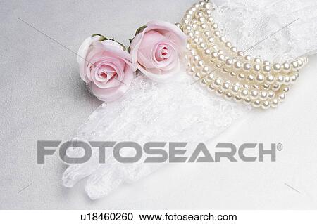 Stock Image - Bridal lace glove, pearls and roses. Fotosearch