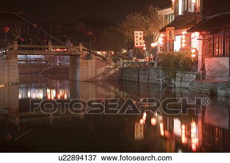 Stock Photo - Bridge and restaurant by river, Xi Tang, China. Fotosearch