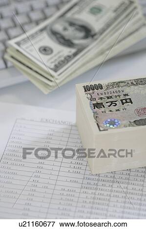 Stock Photo - Bundle of Japanese yen and US dollar bills. Fotosearch