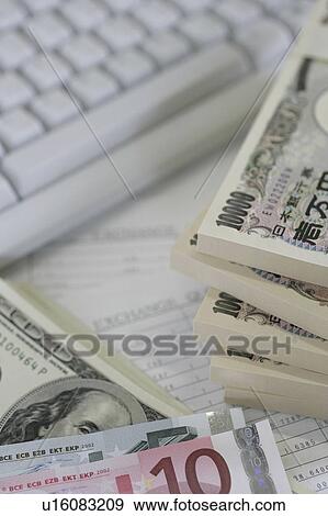 Bundles of different currency and a computer keyboard View Large Photo Image Stock Photo - Bundles of different currency and a computer keyboard. Fotosearch