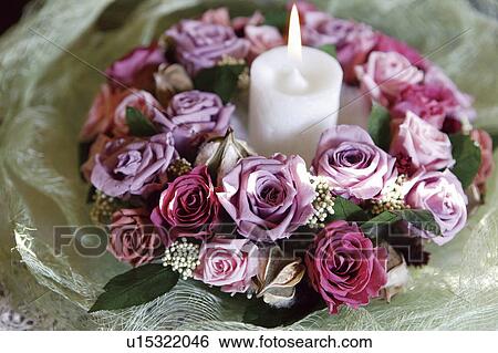 Burning candle surrounded with roses, close up View Large Photo Image Stock Photograph - Burning candle surrounded with roses, close up. Fotosearch