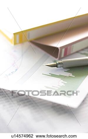 Stock Image - Calligraphy pen, files and documents with graphs. Fotosearch