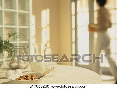 Stock Image - Cereal, milk and eggs on breakfast table. Fotosearch
