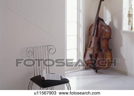 Chair and cello in white room View Large Photo Image Stock Image - Chair and cello in white room. Fotosearch