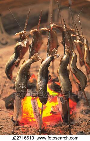 Stock Image - Chargrilled fish on skewers. Fotosearch
