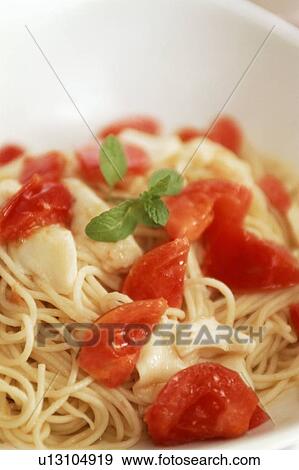 Cheese and tomato spaghetti with herb garnish View Large Photo Image Stock Photo - Cheese and tomato spaghetti with herb garnish. Fotosearch
