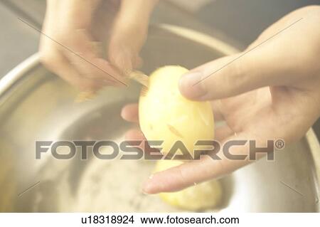 Picture - Chef Peeling Potatoes with his Hands. Tokyo Prefecture, Japan. Fotosearch