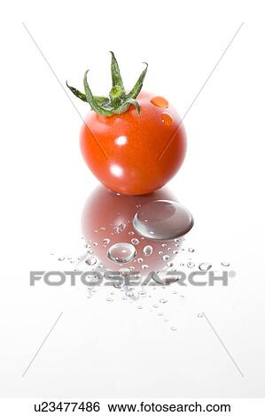 Stock Photograph - Cherry tomato with water droplets. Fotosearch
