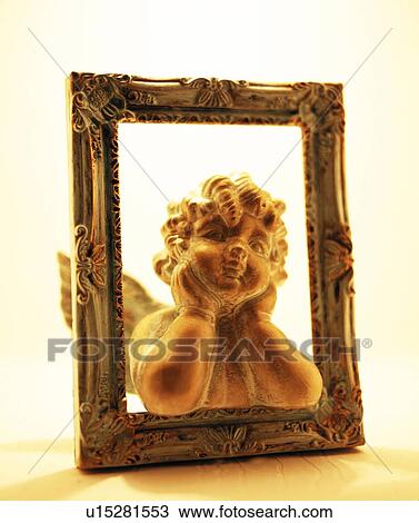 Cherub figurine in picture frame View Large Photo Image Stock Image - Cherub figurine in picture frame. Fotosearch